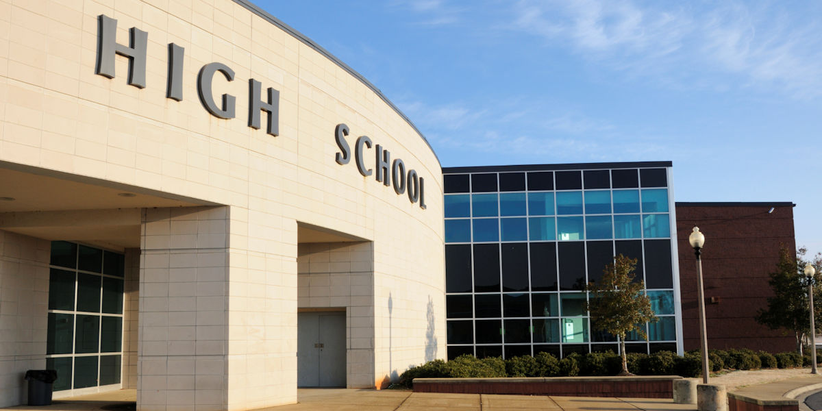 outside of a high school entrance with large windows